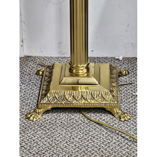 411 - A stunning antique brass standard lamp with lion paw feet base & Corinthian pillar top (shade a/f).