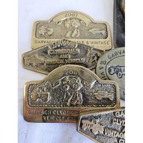 465 - A collection of vintage brass rally plaques.