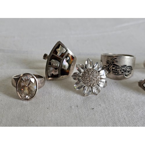 373 - A collection of 8 silver dress rings.