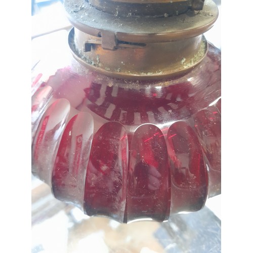 501 - An antique Hinks & Sons ruby glass oil lamp.