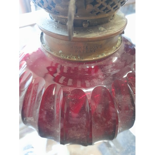 501 - An antique Hinks & Sons ruby glass oil lamp.