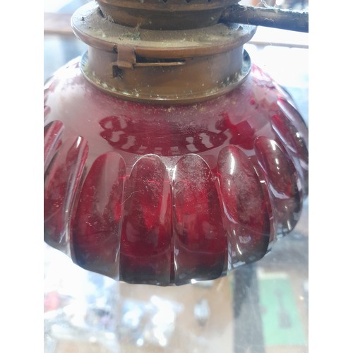 501 - An antique Hinks & Sons ruby glass oil lamp.