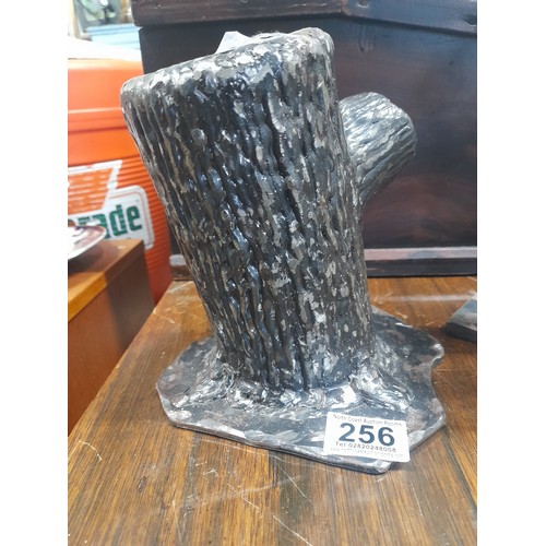 256 - A large cast metal tree stump door stop along with a handmade double candlestick.