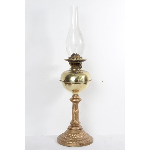 175 - A vintage brass oil lamp with gilt metal base, measuring 65cm tall.