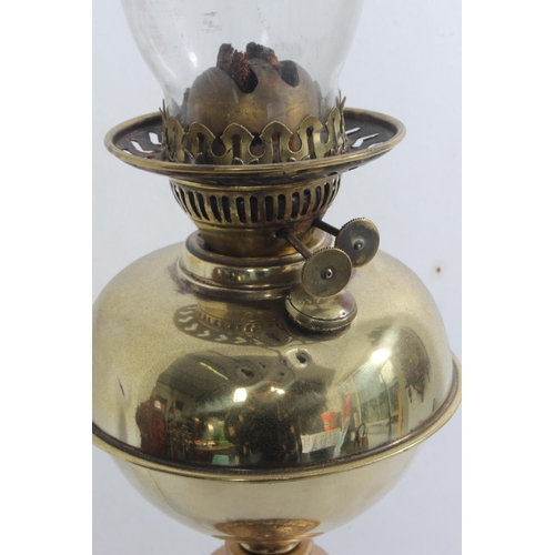 175 - A vintage brass oil lamp with gilt metal base, measuring 65cm tall.