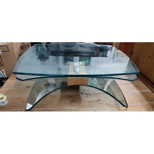 169 - A modernist glass coffee table. 77x 29cm