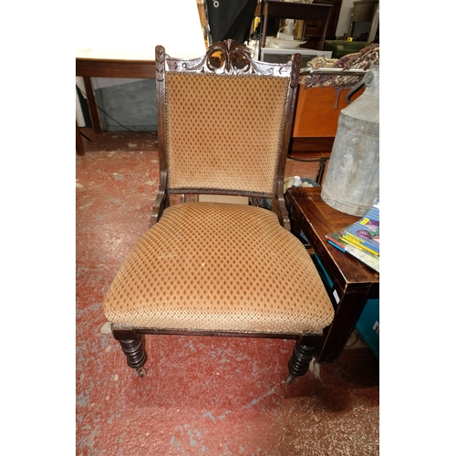 103 - An antique upholstered fireside chair.