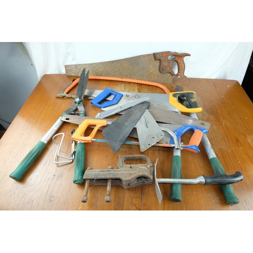 122 - A lot of assorted hand saws and other garden tools etc.