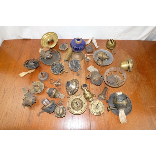 89 - A lot of oil lamp fittings.