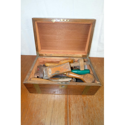 96 - A vintage brass inlaid stationary box containing a lot of vintage hand tools.