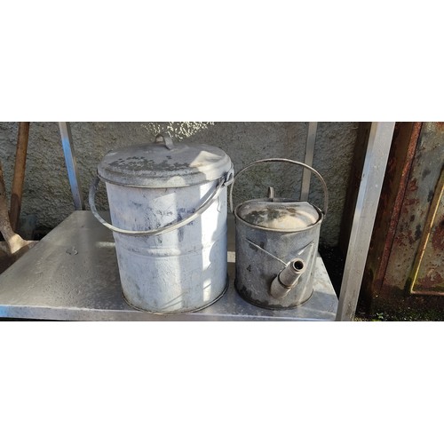 176 - A vintage watering can and a metal container.