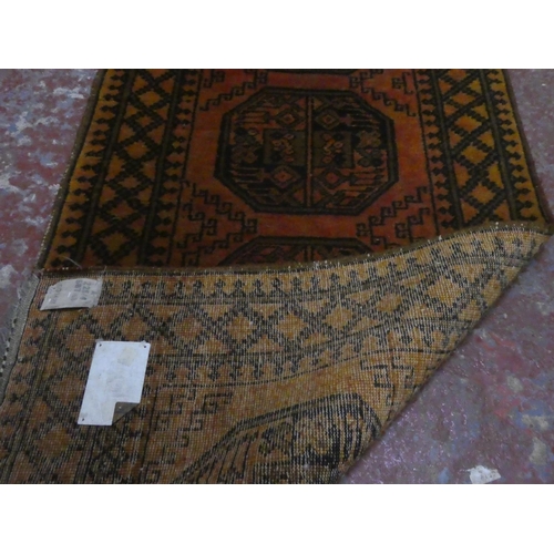 94 - A patterned rug, measuring 180cm x 82cm.