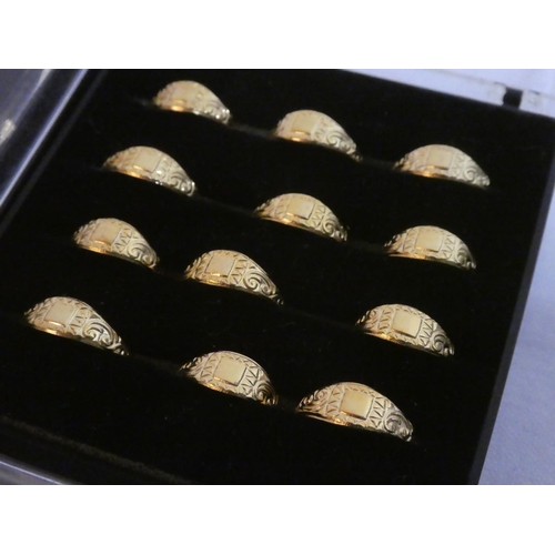 111 - Nine cases of silver and gold coloured metal rings.