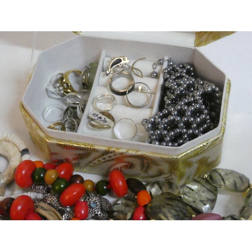 136 - A jewellery box containing a lot of beaded and metal necklaces etc.