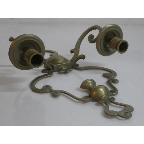 277 - A brass two branch candlestick wall bracket.