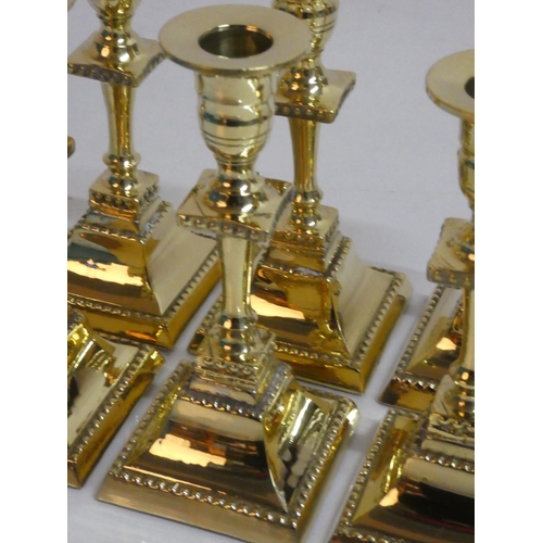 281 - Six brass candlesticks.