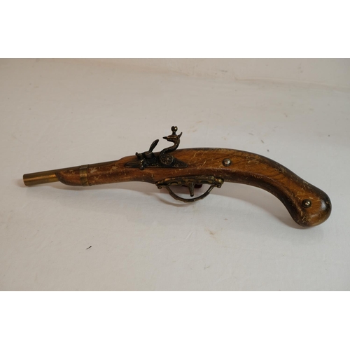 302 - A replica flintlock pistol.