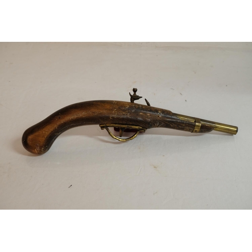 302 - A replica flintlock pistol.