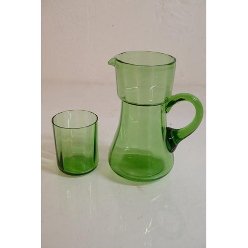 303 - A vintage green glass water jug and glass set.