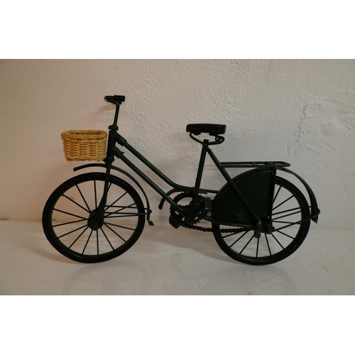 304 - A miniature bicycle with rubber tyres and wicker basket.