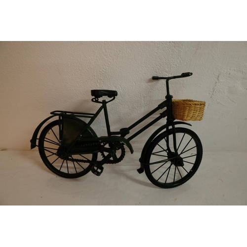 304 - A miniature bicycle with rubber tyres and wicker basket.