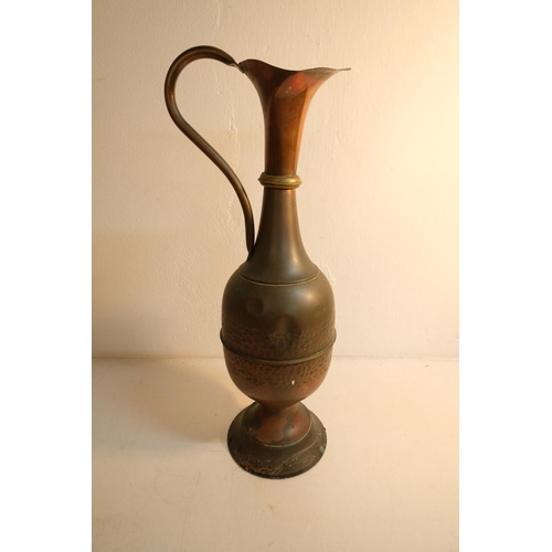 105 - A large vintage copper pitcher, measuring 65cm.