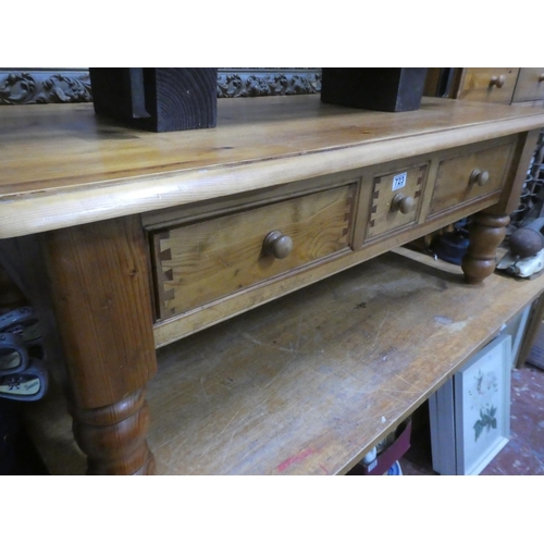 151 - A large pine coffee table with drawers, measuring 124cm x 49cm x 79cm.