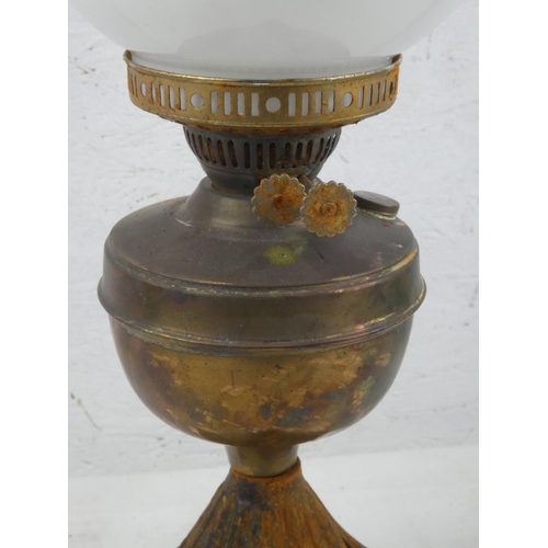 158 - A vintage oil lamp with milk glass football shade and chimney.