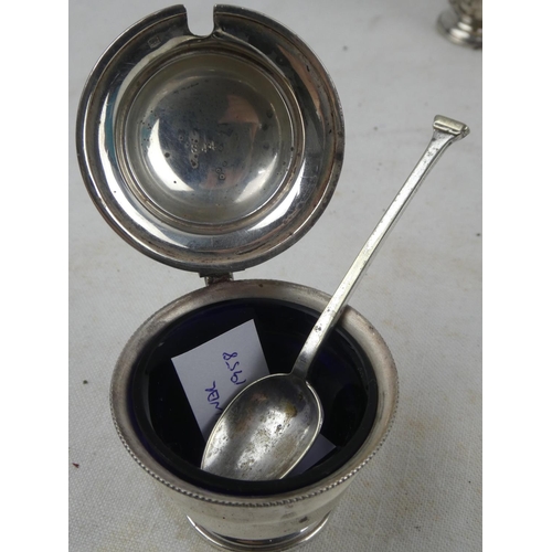 202 - A pair of Sterling Silver salt and pepper set and a Sterling Silver mustard pot with spoon.