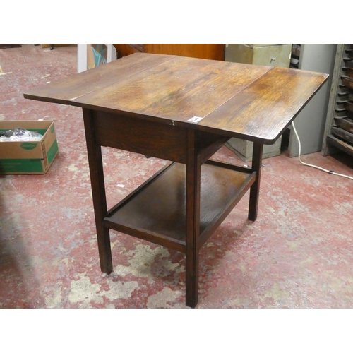 252 - A vintage oak drop leaf table, with end drawer and undershelf, measuring 69cm x 66cm x 38cm.