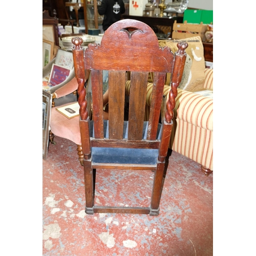 262 - A rare mid 17th Century Oak armchair with decorative carved panels, measuring 115cm.