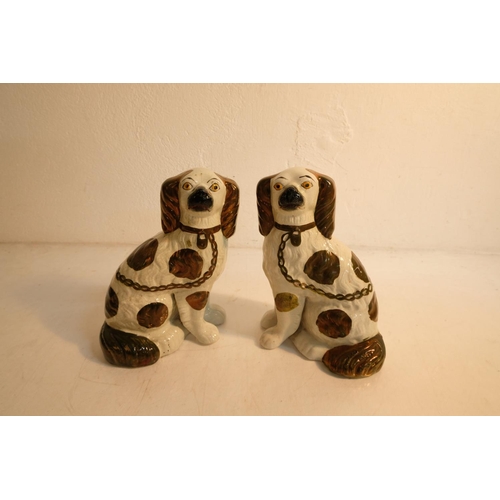 309 - A pair of antique style mantle dogs. Measuring 23cm