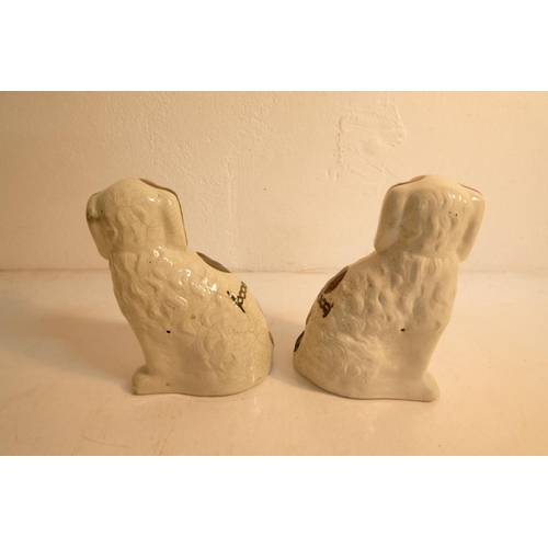 309 - A pair of antique style mantle dogs. Measuring 23cm