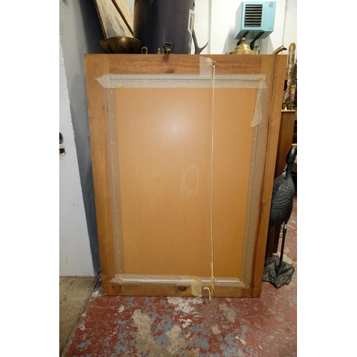 65 - A large pine framed wall mirror, measuring 79cm x 110cm.