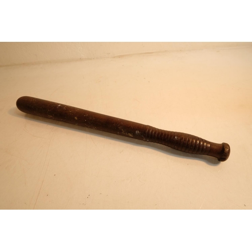 74 - An antique police batton, measuring 44cm