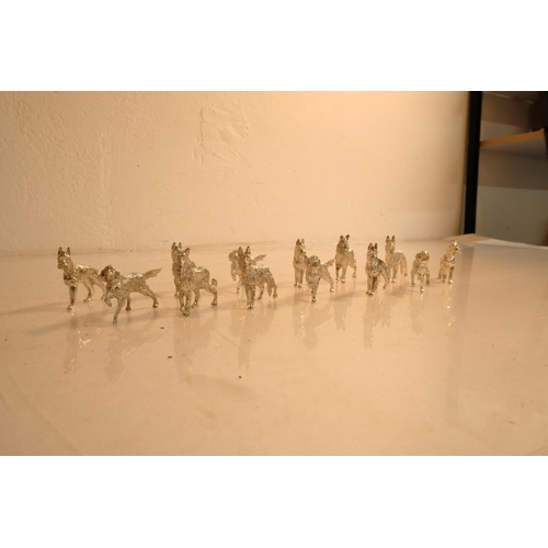 84 - A collection of metal dog figures.