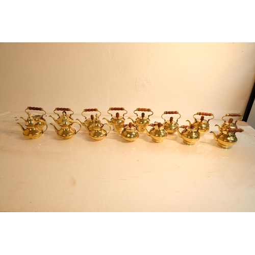 333 - A lot of 15 miniature brass teapots.