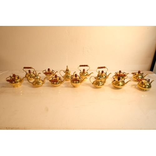 336 - A lot of 14 miniature brass teapots.