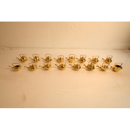 344 - A lot of 16 miniature brass teapots.