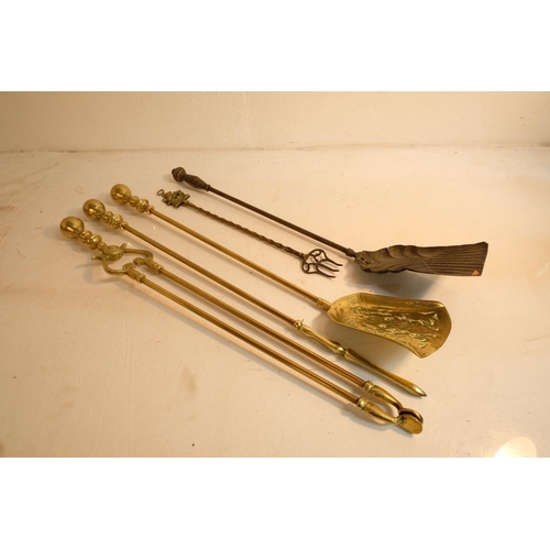 359 - An antique set of brass fire irons, a pair or antique fire dogs, a ship handled toasting fork and mo... 