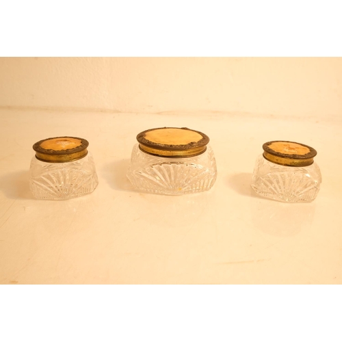 372 - Two vintage glass dressing table jars engraved with a floral design.