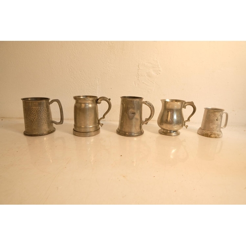 383 - A lot of vintage pewter and metal tankards.