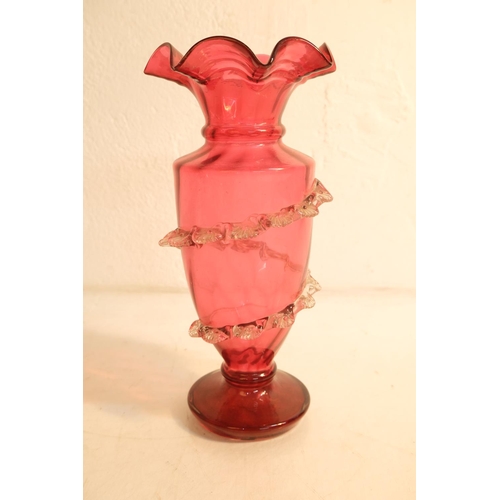 392 - An antique/ Victorian Ruby glass vases with decorative design, measuring 27cm.