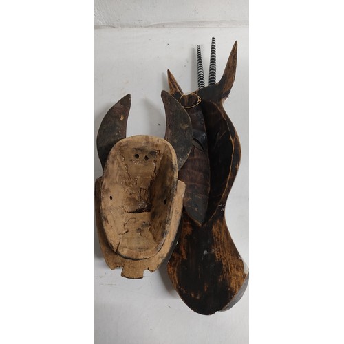 75 - A hand carved wooden tribal mask, measuring 36cm and wooden mask in the style of an animals head, me... 