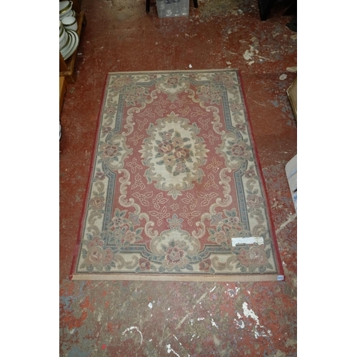 378 - A floral patterned floor rug, measuring 166cm x 114cm.