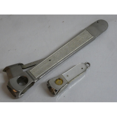 484 - A vintage Pfeilring Solingen cigar cutter and another pocket cigar cutter.