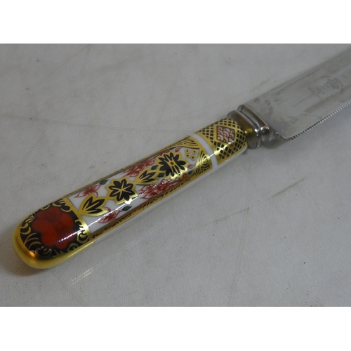 498 - A Royal Crown Derby bread knife in its presentation box.