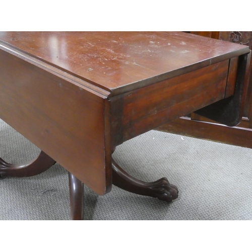 552 - An antique mahogany drop leaf dining table on centre pedestal with claw feet detail.