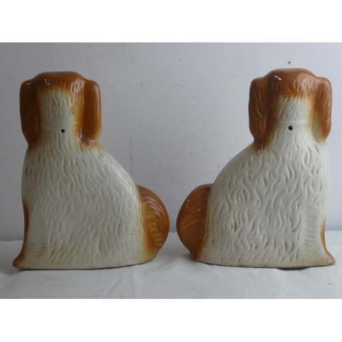 15 - A pair of antique mantle dogs (a/f).