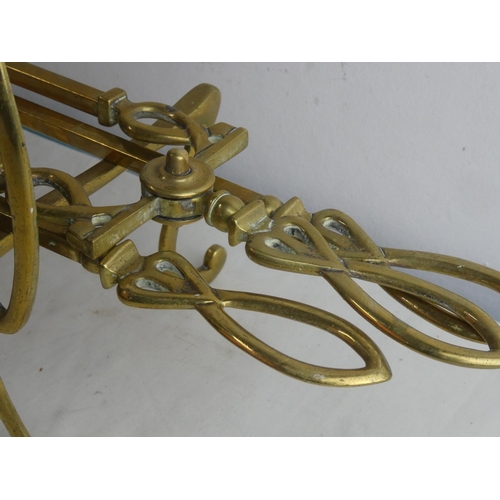 105 - An antique/ Art Nouveau style set of brass fire irons and dogs.